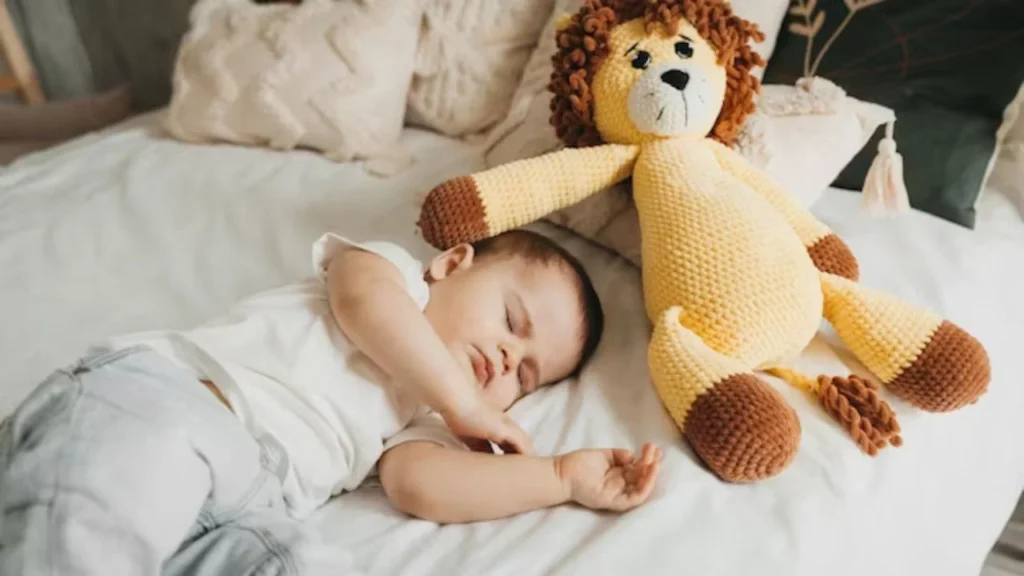 Baby surrounded by stuffed animals, laughing joyfully.