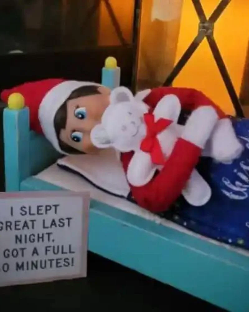 50 Last Minute Elf on the Shelf ideas-Taking a Nap in the Doll's Bed