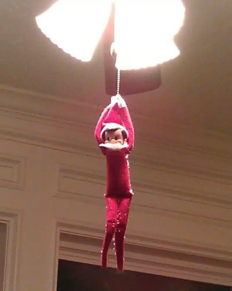 50 Last Minute Elf on the Shelf ideas-Swinging from the Light Apparatus